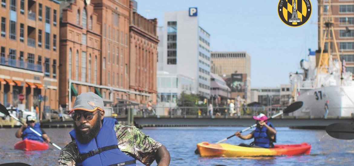 Photo of three people kayaking in the inner harbor. Heading reads "Fiscal 2023 Executive Summary Board of Estimates Recommendations". Below is a subheading "Mayor Brandon M. Scott City of Baltimore, Maryland" and is the City logo.
